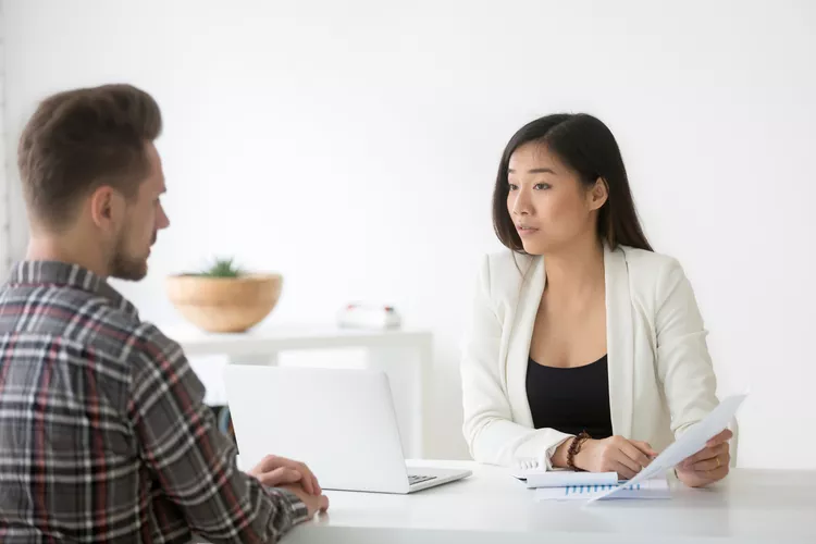 distrustful serious asian business woman discussing business